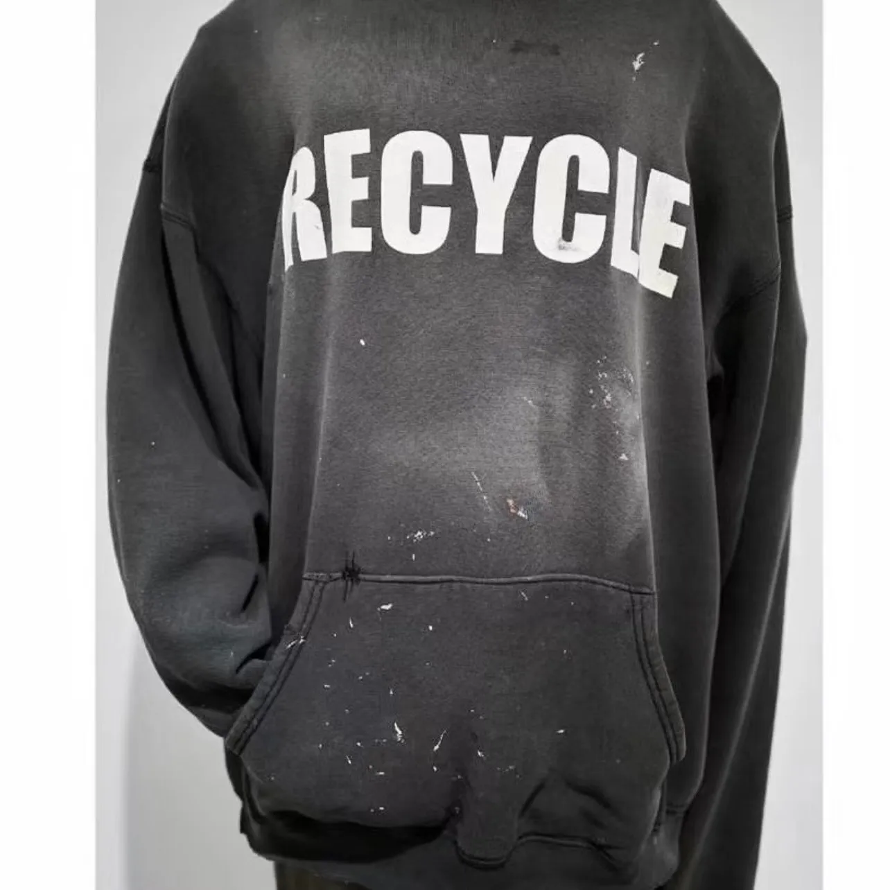 GALLERY DEPT. 90'S RECYCLE HOODIE WASHED BLACK 90'S washed hoodie with distressed eco-friendly slogans. Washed black S-XL. Ready-made garments are washed and dyed again. Multiple spots throughout the body are spray-faded. The ribs are cut and worn.